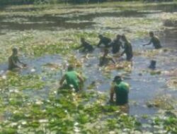 Bersama Warga, Bhabinkamtibmas Pantau Pembersihan Enceng Gondok di Sungai